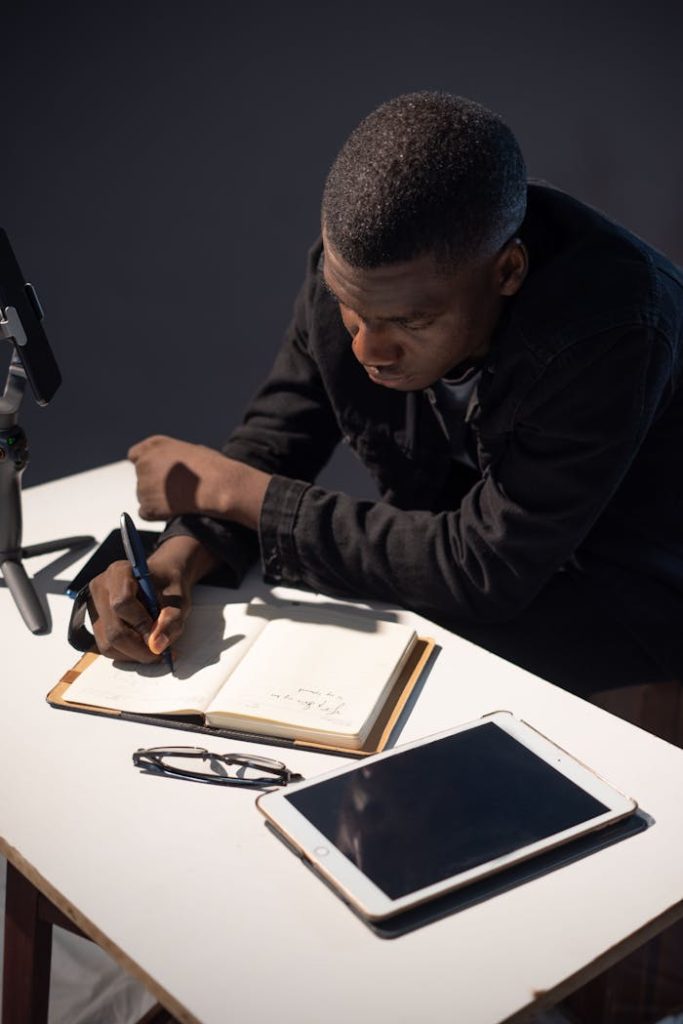 A man sitting at a desk with a tablet and pen